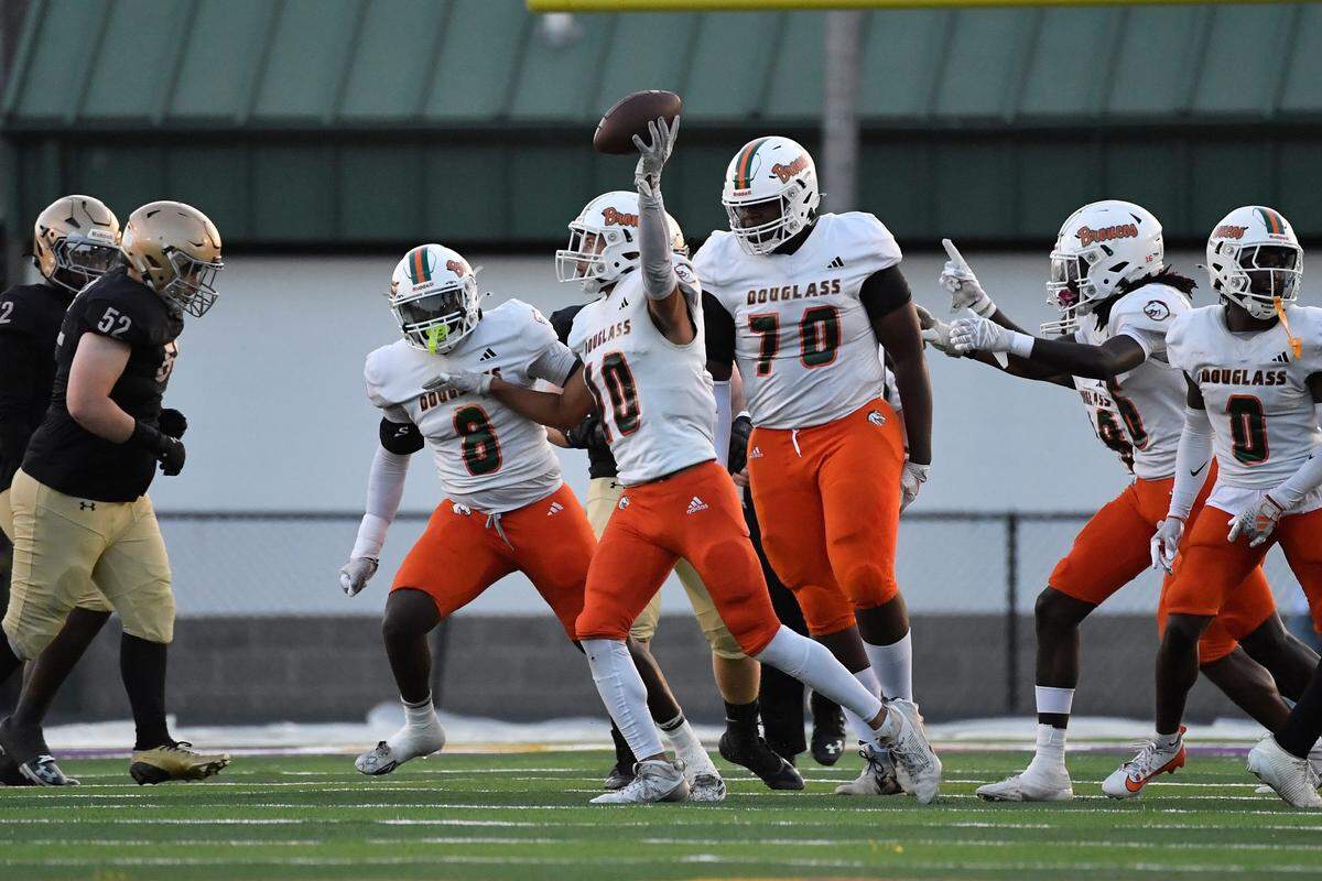 Frederick Douglass' Keenan Banther (10) celebrates with teammates after recovering a loose ball during the first half of their game against Male, Friday, Oct. 3 2025 in Louisville Ky.
