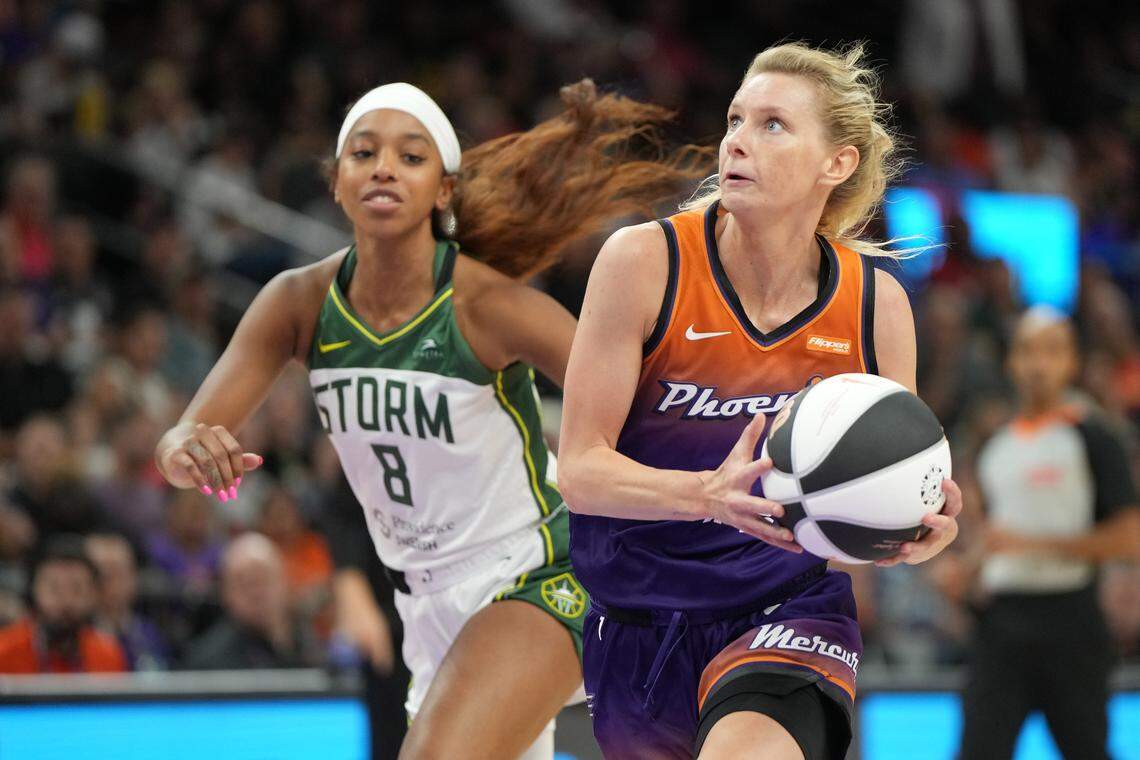 Jun 7, 2025; Phoenix, Arizona, USA; Phoenix Mercury guard Lexi Held (1) drives past Seattle Storm guard Lexie Brown (8) in the second half at Footprint Center. Mandatory Credit: Rick Scuteri-Imagn Images