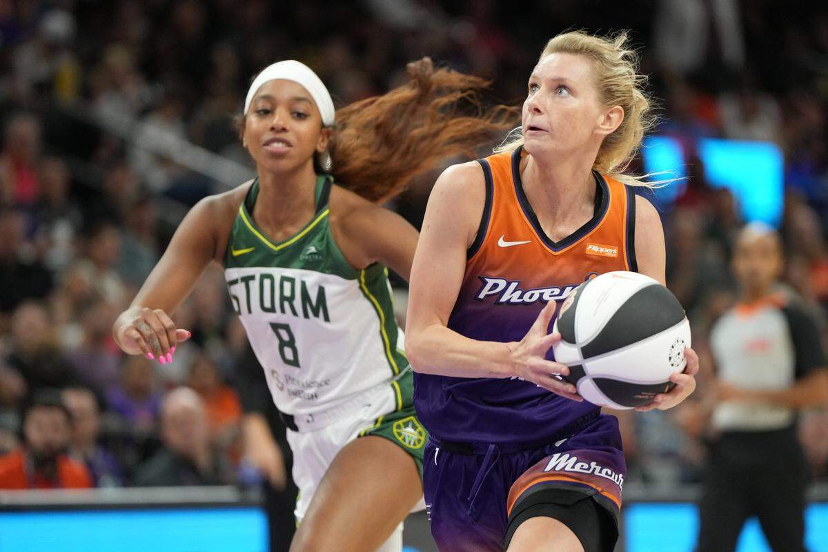 Jun 7, 2025; Phoenix, Arizona, USA; Phoenix Mercury guard Lexi Held (1) drives past Seattle Storm guard Lexie Brown (8) in the second half at Footprint Center. Mandatory Credit: Rick Scuteri-Imagn Images