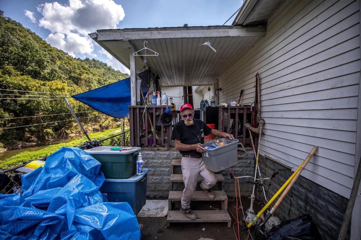 Jack Alsept, along with his wife, Sherry, are staying in tents at their flooded house in Perry County, Ky., as they work to clean and salvage what they can.