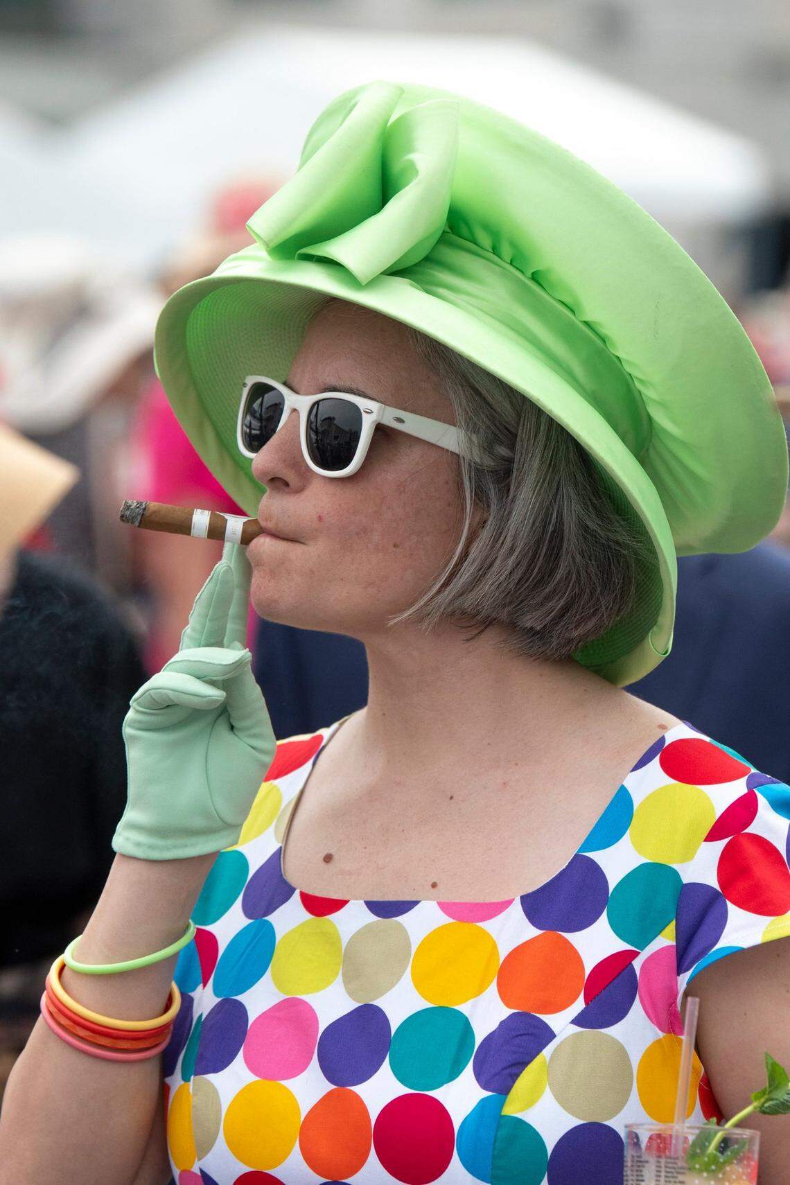 People walk around Churchill Downs ahead of the Kentucky Derby in Louisville, Ky., on Saturday, May 6, 2023.