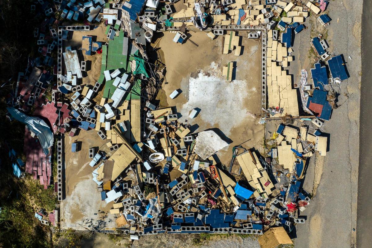 Cinderblocks are scattered around a lot on Thursday, Aug. 4, 2022, where a house was washed away during flash flooding near Dwarf, Ky.
