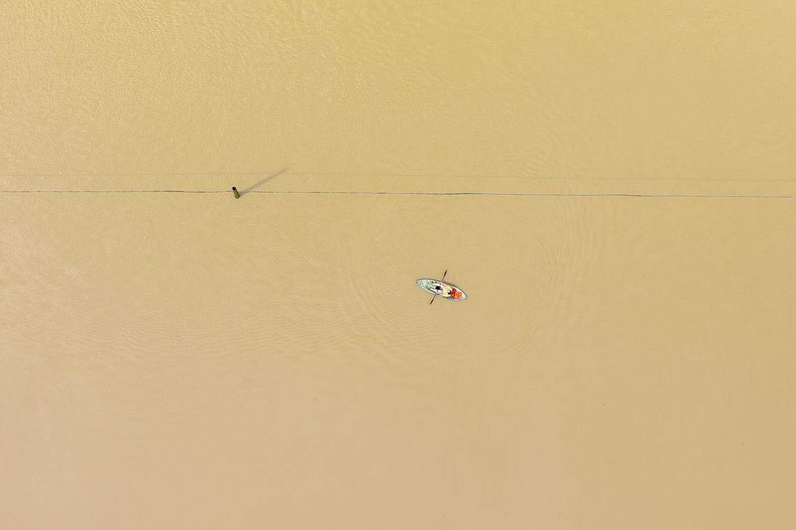 A person kayaks along flooded Kentucky Route 39 near Crab Orchard in Lincoln County, Ky., on Friday, April 4, 2025.