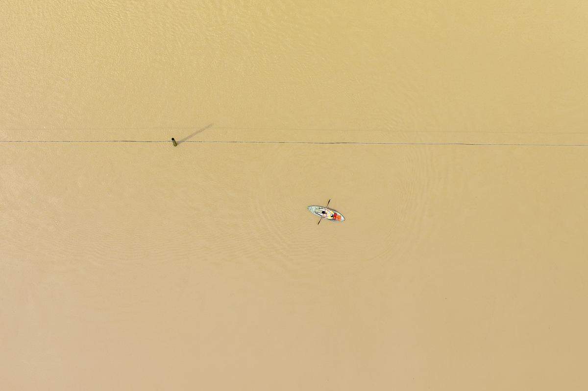 A person kayaks along flooded Kentucky Route 39 near Crab Orchard in Lincoln County, Ky., on Friday, April 4, 2025.