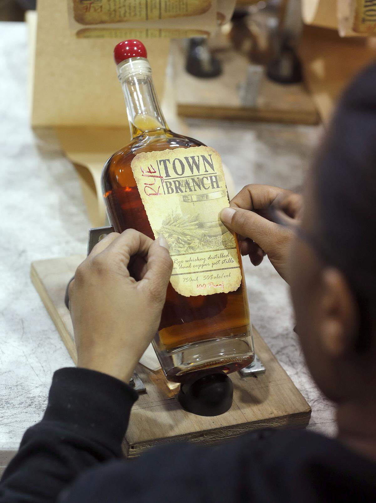Jawanda Gentry placed a label on a bottle of Town Branch Rye in the bottling area at the Alltech distillery, 900 W. Maxwell St. in Lexington, Ky., Monday, February 03, 2014.