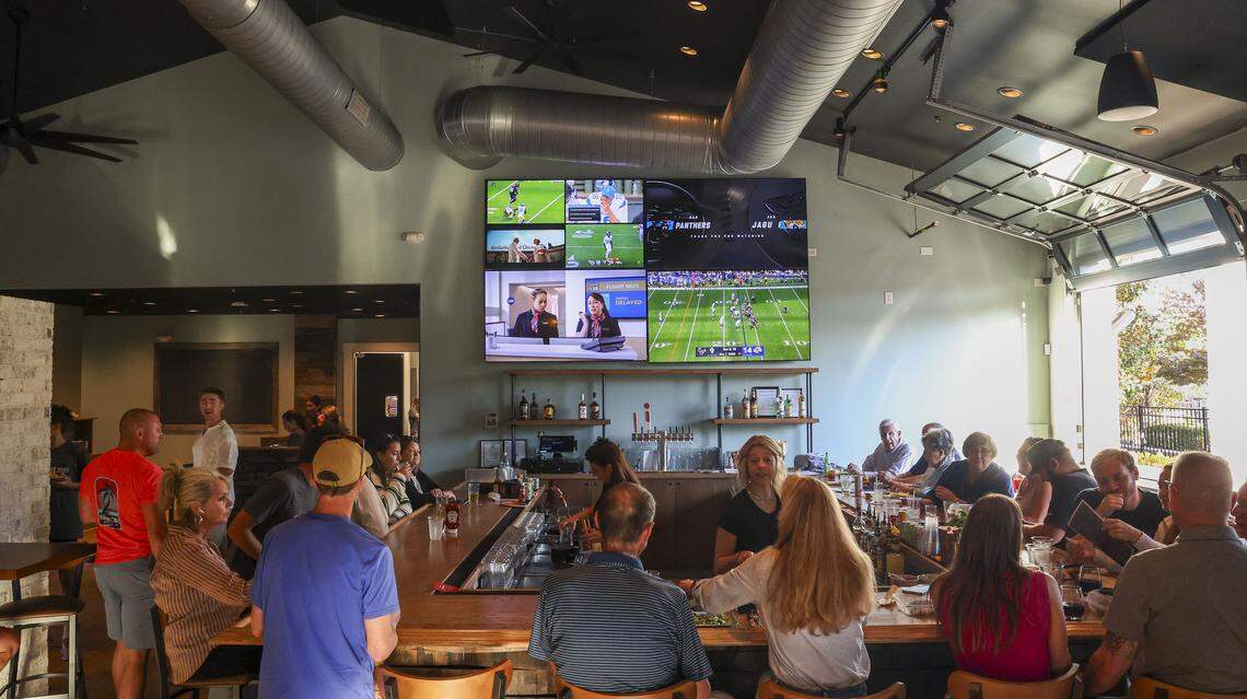 The bar area at Southern Cookhouse & Bar, photographed Sunday, Sept.  7, in Lexington, Ky., has four 85-inch TVs on the wall. The renovation of the restaurant included doubling the size of the bar.