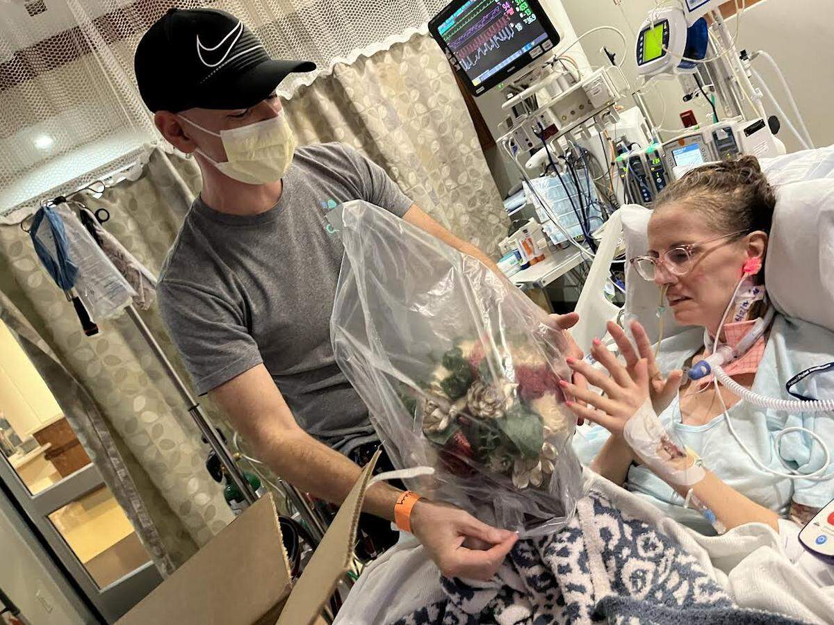 Jeff and Emily Presley celebrate their 23rd wedding anniversary at UK Chandler hospital where she has been attached to a life-saving ECMO machine after a bacterial infection ravaged her lungs. The flowers are made of wood. Real flowers aren’t allowed in intensive care.