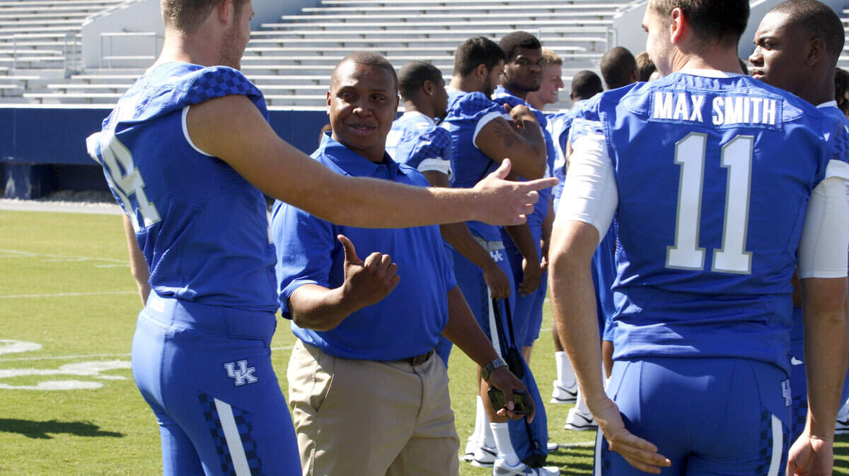 Running backs coach Chad Scott, a former UK player, chatted with quarterback Patrick Towles during UK Football Media Day last week.