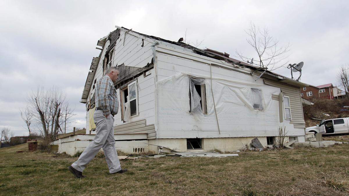 Then Morgan County-Judge Executive Tim Conley walked by a damaged house in West Liberty on Feb. 20, 2013, nearly a year after a tornado damaged much of the area. Conley pleaded guilty last year to a charge stemming from a kickback scheme involving local building projects.