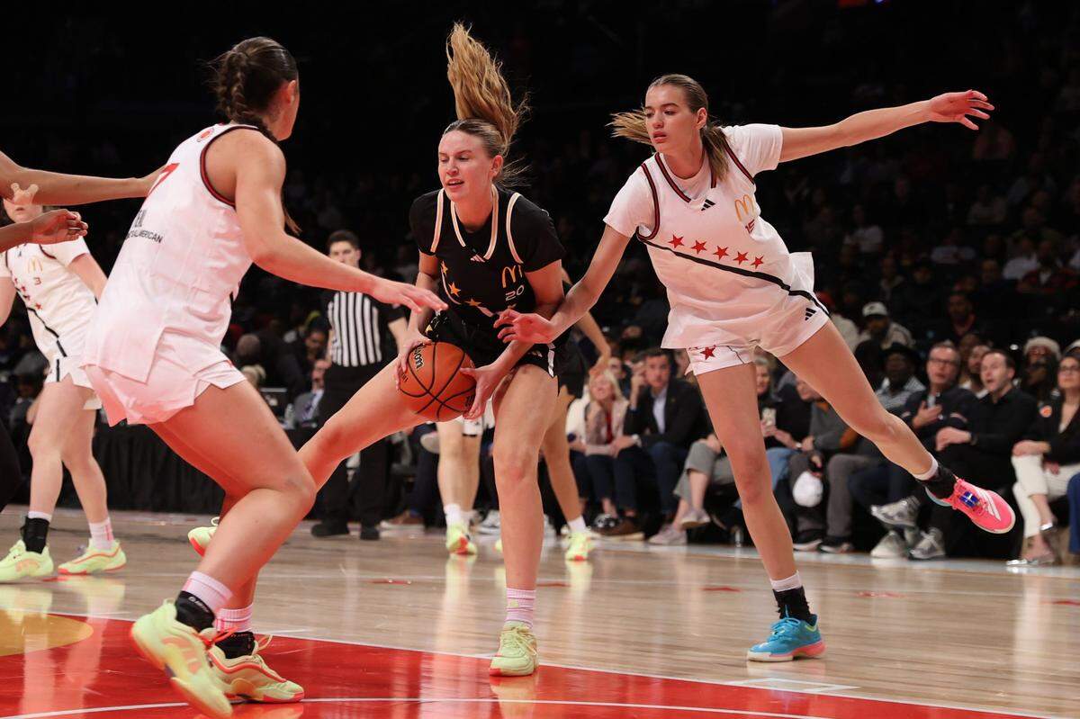 Kaelyn Carroll (middle) is the first McDonald’s All-American that coach Kenny Brooks has ever signed out of high school.