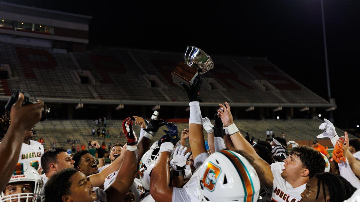 Frederick Douglass celebrates after winning its game against Bowling Green in the Rafferty’s Bowl, 35-13, at WKU.