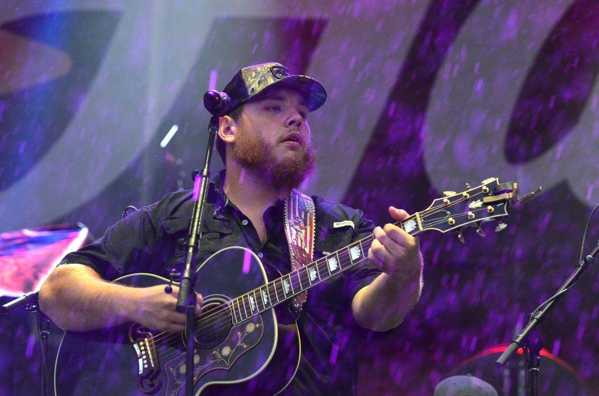 Luke Combs played “When It Rains It Pours” in appropriate weather during heavy rains from the remnants of Hurricane Harvey at Red, White & Boom in 2017 at Whitaker Bank Ballpark.