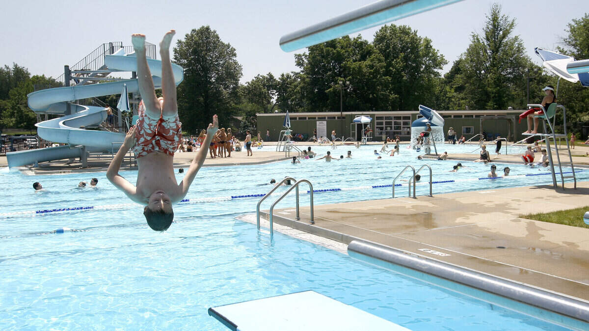 Chandler Hayhurst, 10, does a back flip off the diving board at Southland Aquatic Center in Lexington, Ky., Sunday, May 29, 2011. Photo by Matt Goins 12070