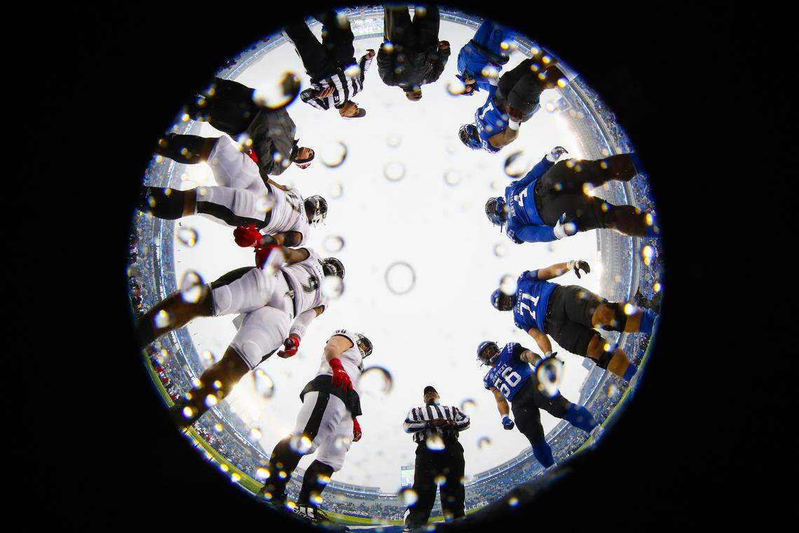 The Kentucky Wildcats and the Louisville Cardinals line up for the coin toss before their game at Kroger Field in Lexington, Ky., Saturday, Nov. 30, 2019.
