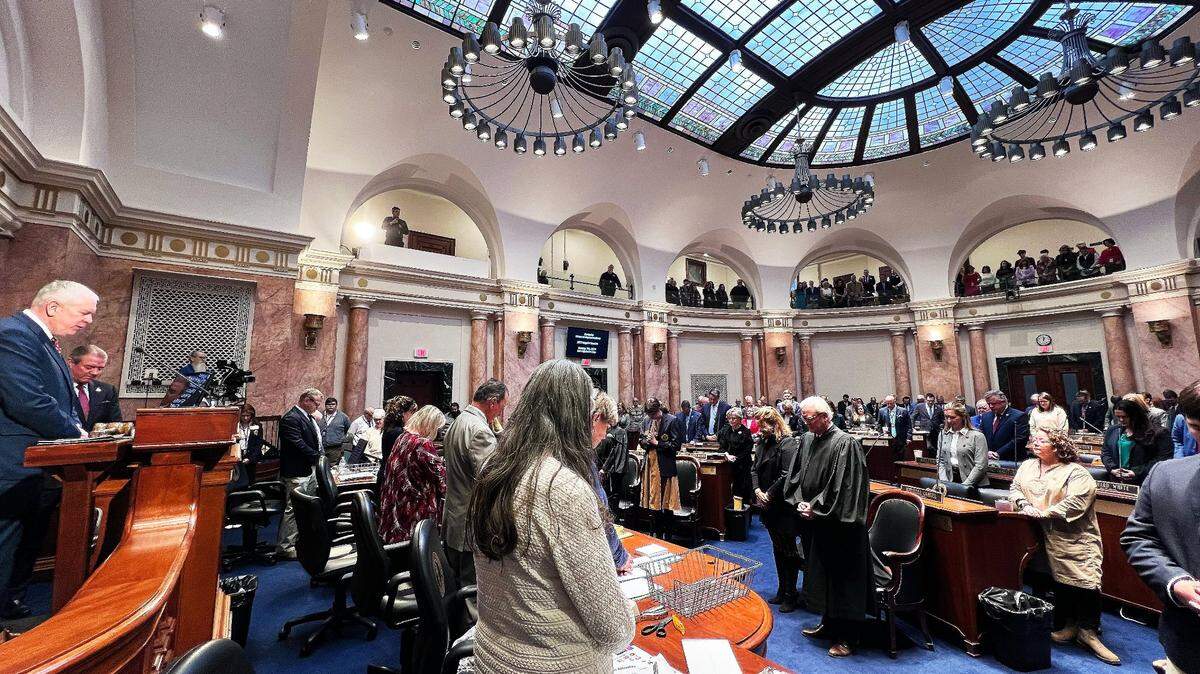 Representatives bow their heads in prayer on the Kentucky House of Representatives floor before the 2025 Regular Session, First Legislative Day on January 7, 2025.