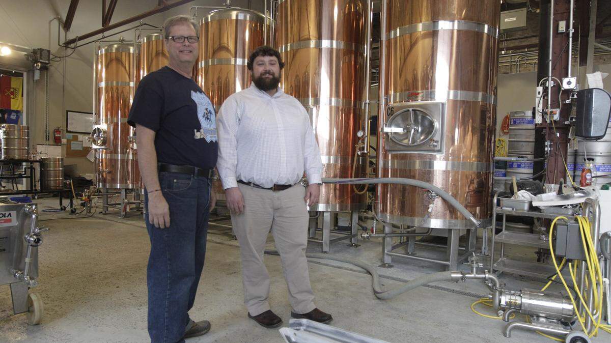Jim Clemons, left, and Kore Donnelly, co-owners of Blue Stallion Brewing, posed Wednesday in their plant on West Third Street in Lexington.