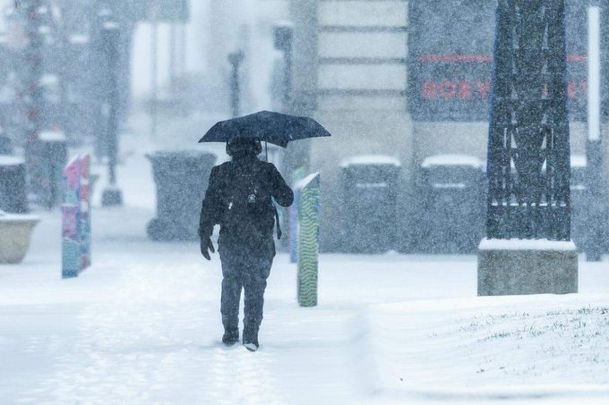 An individual walks through the snow in Lexington Sunday, Jan. 5, 2025, as a winter storm hits the region.