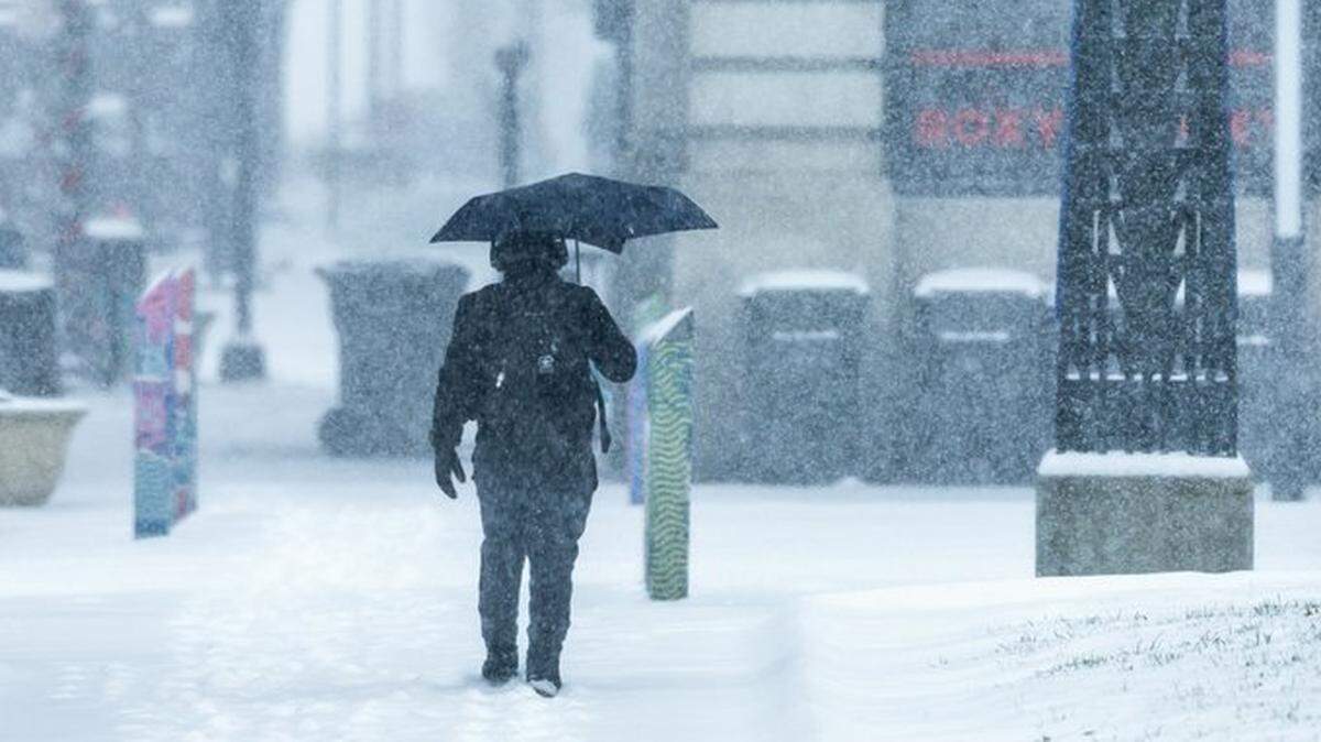An individual walks through the snow in Lexington Sunday, Jan. 5, 2025, as a winter storm hits the region.