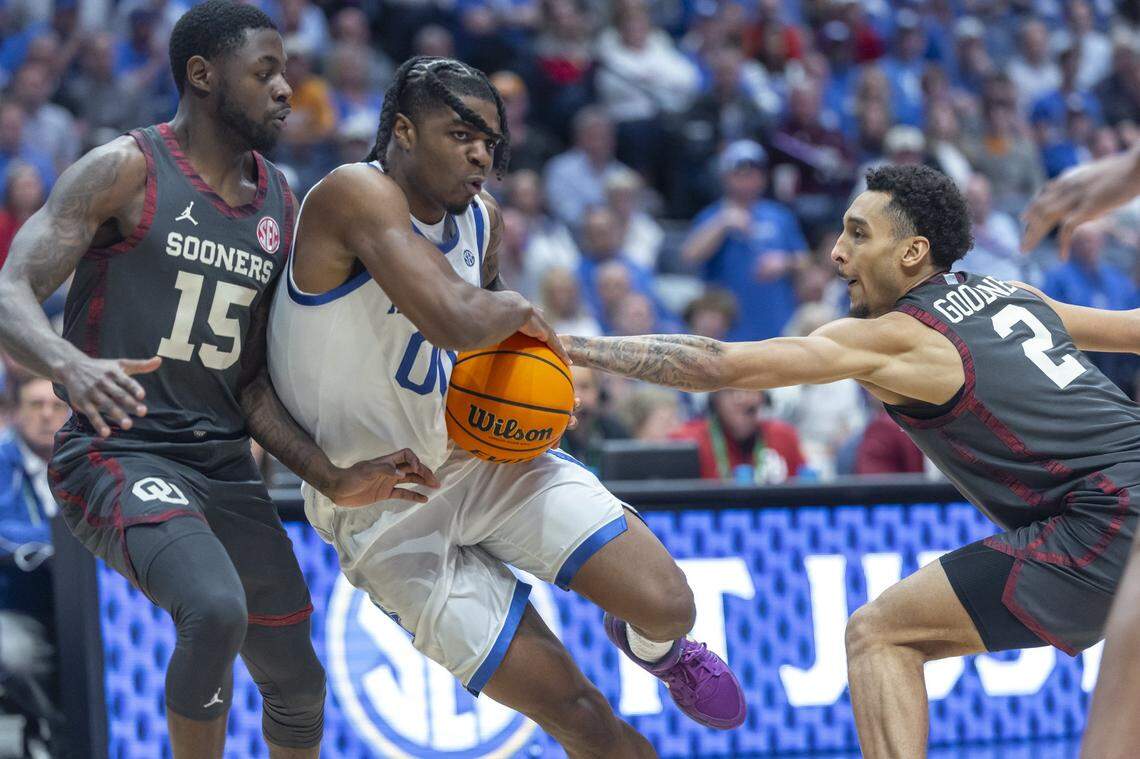 Kentucky guard Otega Oweh (00) drives the ball as Oklahoma guards Duke Miles (15) and Brycen Goodine defend during an SEC Tournament game at Bridgestone Arena in Nashville, Tennessee, on March 13.