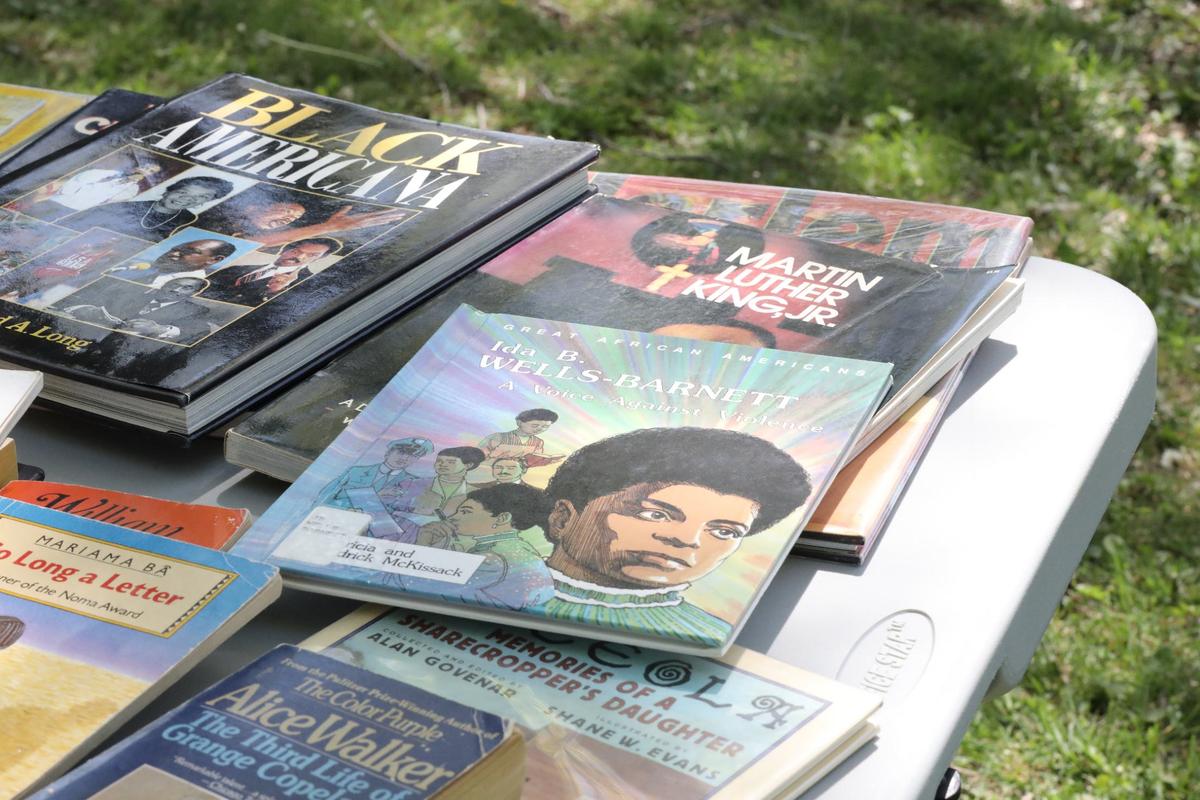 The story of Black female journalist Ida B. Wells-Barnett, “The Third Life of Grange Copeland,” the debut novel of Black American author Alice Walker, and “Black Americana” by Richard A. Long are on display during The People’s Porch and FoodChain Lex’s Drop Everything and Read event on April 20, 2024, at Coolavin Park in Lexington, Ky.