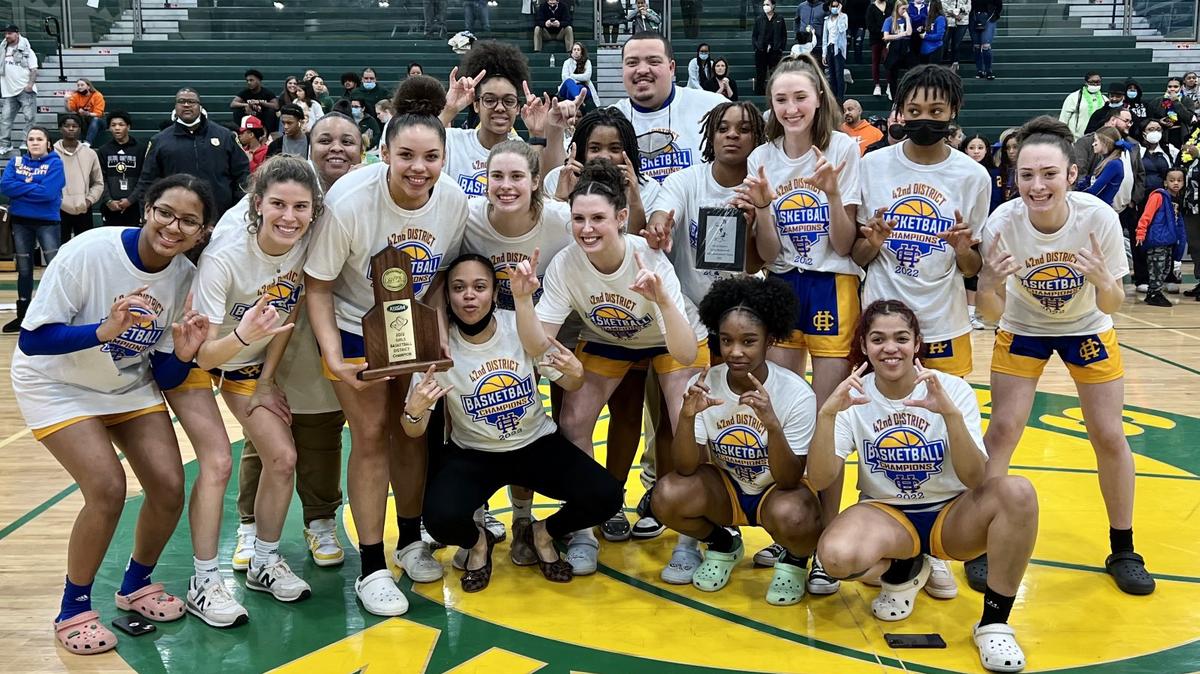 Henry Clay celebrated with the 42nd District Tournament championship trophy and pieces of the game net after its 58-55 win over Bryan Station on Friday night.