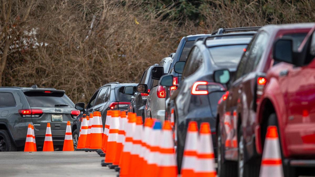 People wait in line for a COVID-19 test at Wild Health’s testing site at 1505 College Way on the University of Kentucky campus in Lexington, Ky., on Monday, Dec. 27, 2021.