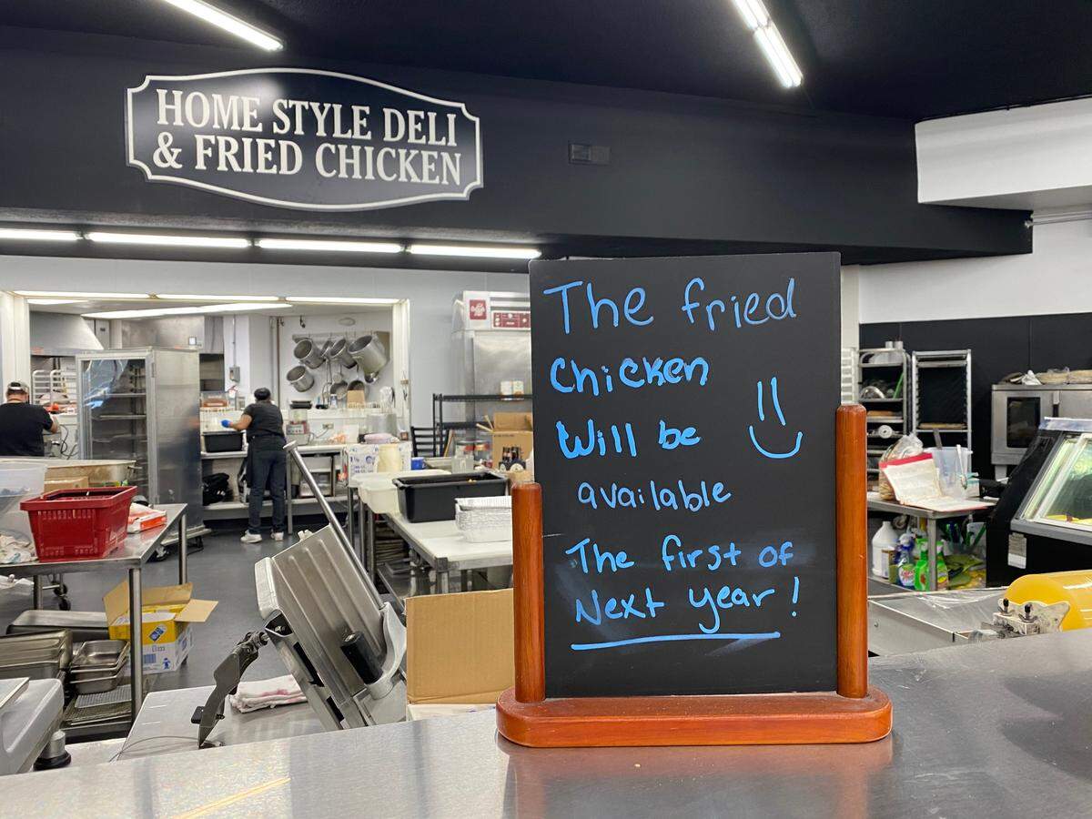 A sign at the new Critchfield Meats Family Market promises to bring back the popular “Save-A-Lot” fried chicken as soon as renovations to the deli are ready.