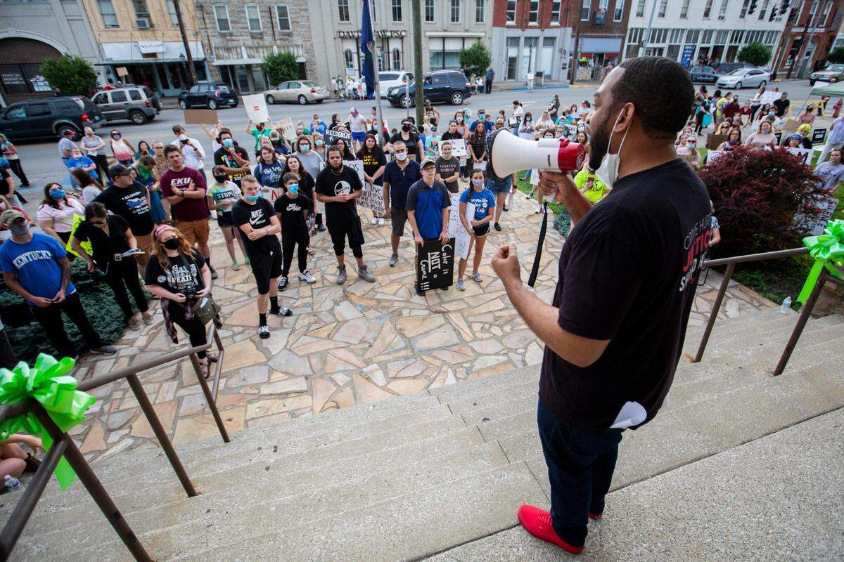 Rep. Charles Booker speaks to the crowd of protesters gather in front of the Estill County courthouse during a Black Lives Matter protest in Irvine, Ky., Monday, June 8, 2020.
