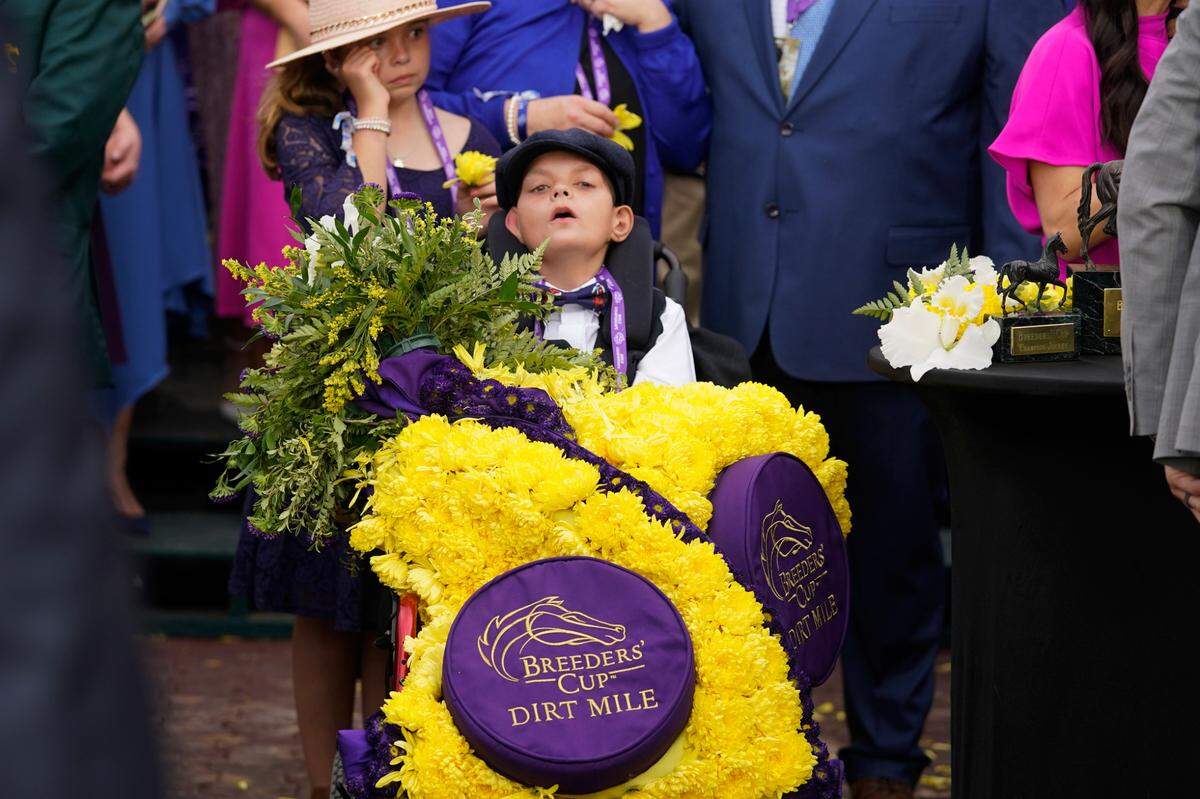 Cody Dorman wears the winner’s flower sash after Cody’s Wish’s win in the Breeders’ Cup Dirt Mile race at the Keenelend Race Course, Saturday, Nov. 5, 2022, in Lexington, Ky. (AP Photo/Darron Cummings)