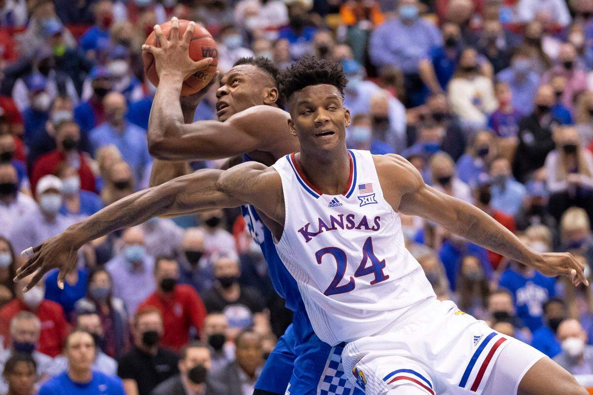 Kentucky Wildcats forward Oscar Tshiebwe (34) shoots the ball around Kansas Jayhawks forward K.J. Adams (24) during a game at Allen Fieldhouse in Lawrence, Kansas, on Saturday, Jan. 29, 2022.
