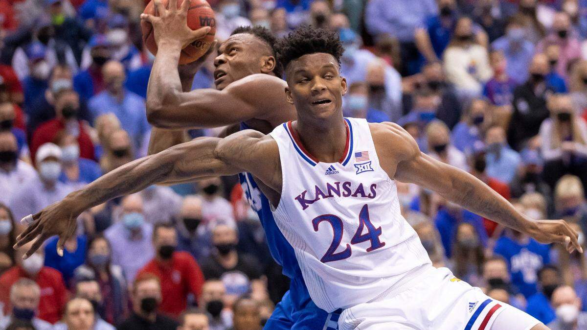 Kentucky Wildcats forward Oscar Tshiebwe (34) shoots the ball around Kansas Jayhawks forward K.J. Adams (24) during a game at Allen Fieldhouse in Lawrence, Kansas, on Saturday, Jan. 29, 2022.
