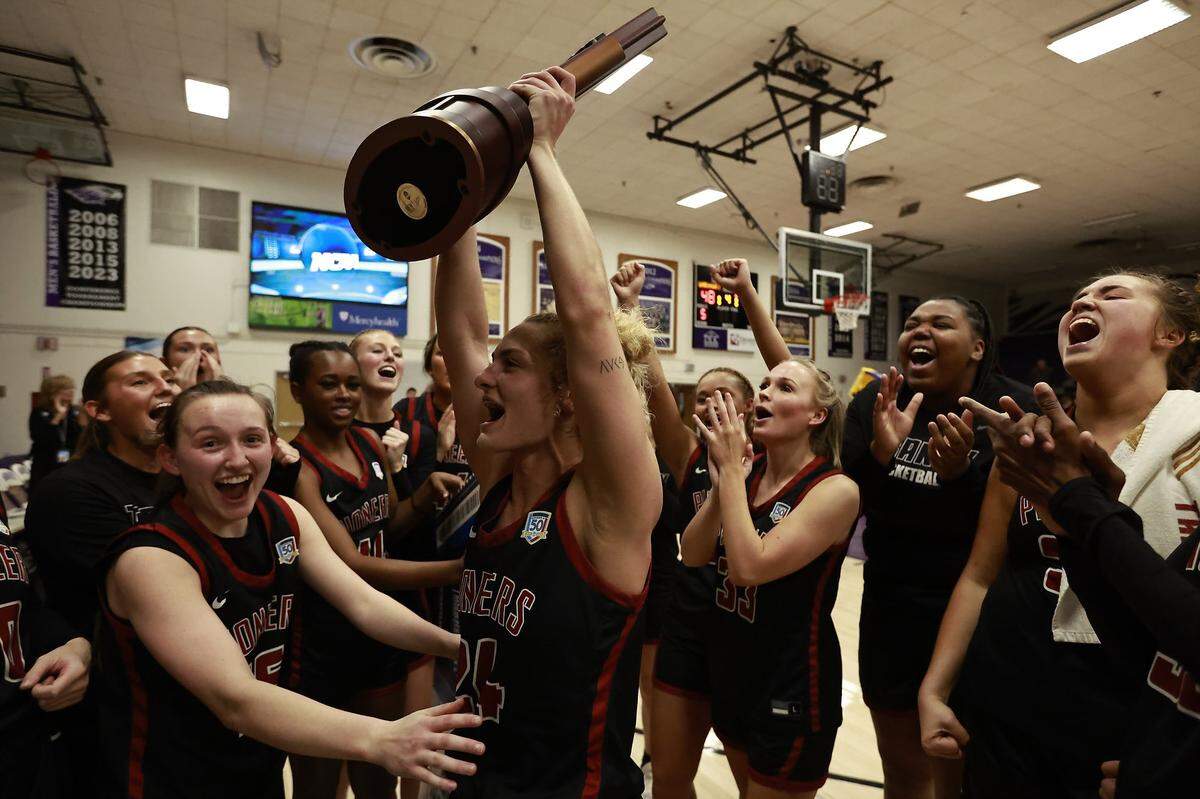 Transylvania’s Kennedi Stacy (24) and her teammates celebrate their victory against Wisconsin-Whitewater in the NCAA Division IIII Tournament’s Elite Eight.
