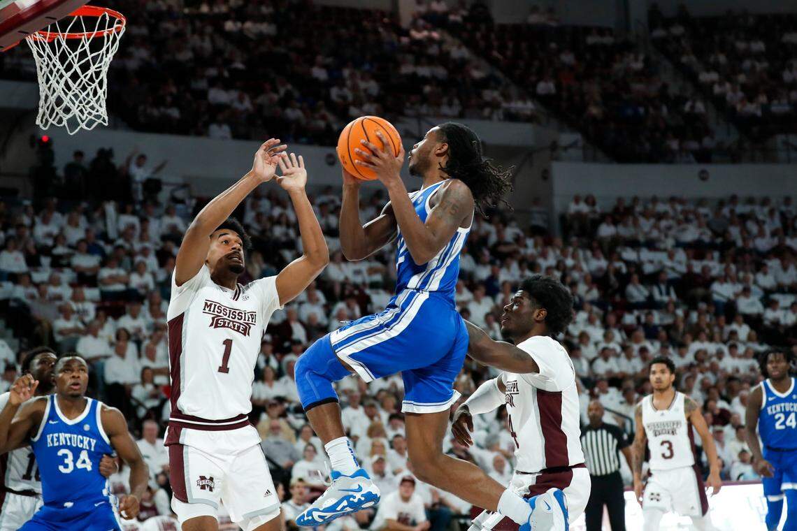 Kentucky’s Cason Wallace (22) drives to the basket against Mississippi State’s Tolu Smith (1) on Wednesday night. Wallace finished with 11 assists but scored only four points on 1-for-13 shooting.