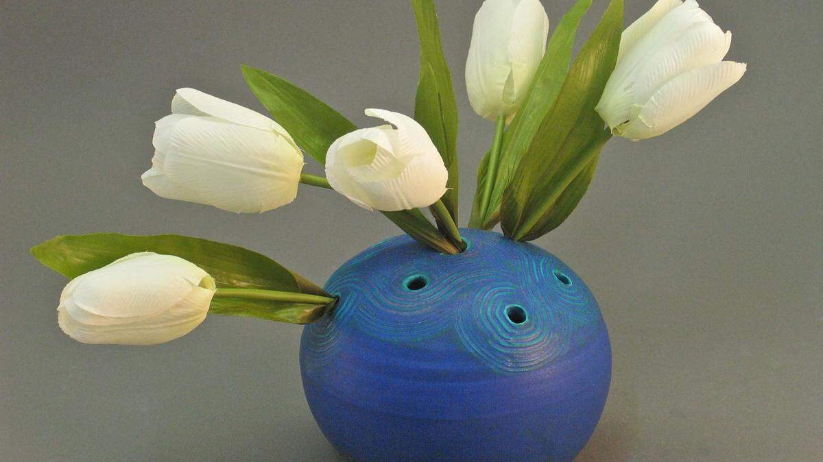 "Flower ball" flower frogs, by Amy Elswick of Clay House Pots, have small holes at the top for cut stems. They're perfect for arranging spring tulips.