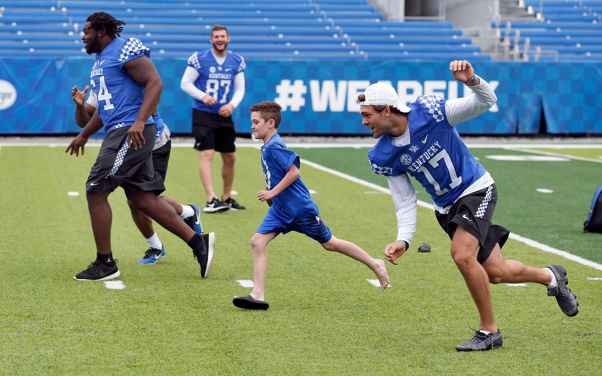 Luke Klausing played with some University of Kentucky football players after he had  a “signing day” ceremony Wednesday morning. Leading him on a run was George Asafo-Adjei (64), C.J. Conrad (87) and Walker Wood (17).