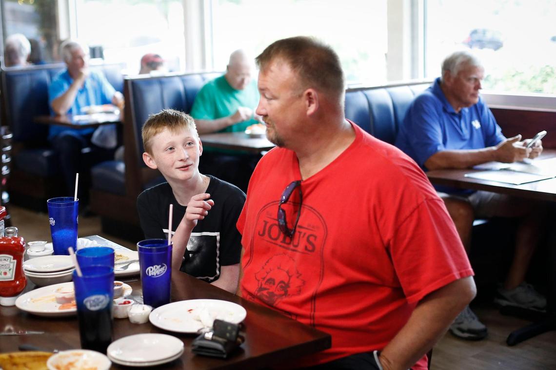 Tyler Wells, 11, jokes with his dad Marty Wells, both of Georgetown, as they finish their lunch at Jerry’s Restaurant in Paris, Wednesday, July 7, 2021.