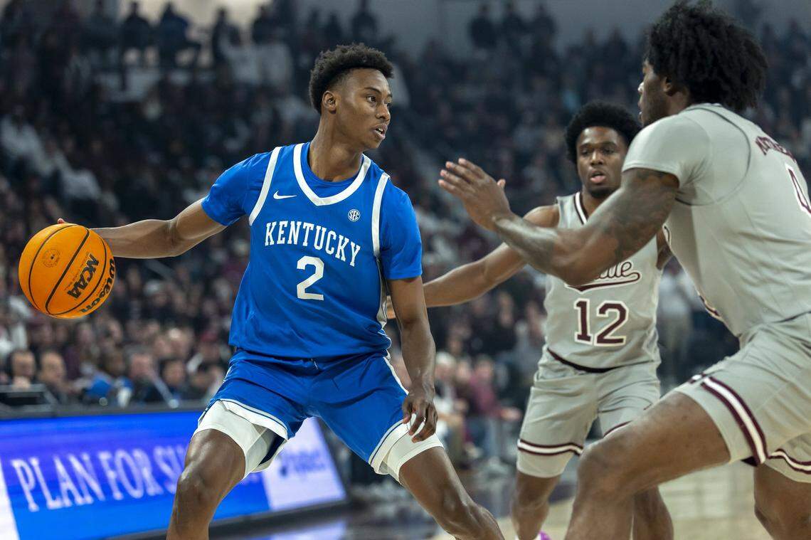 Kentucky guard Jaxson Robinson (2) looks to move the ball as Mississippi State guard Josh Hubbard (12) and forward Cameron Matthews (4) defend during Saturday’s game at Humphrey Coliseum in Starkville, Miss.