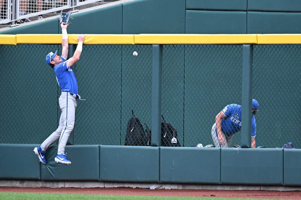 Jun 19, 2024; Omaha, NE, USA;  Wildcats right fielder James McCoy (13) jumps but cannot catch a home run against the Florida Gators during the first inning at Charles Schwab Field Omaha. Mandatory Credit: Steven Branscombe-USA TODAY Sports