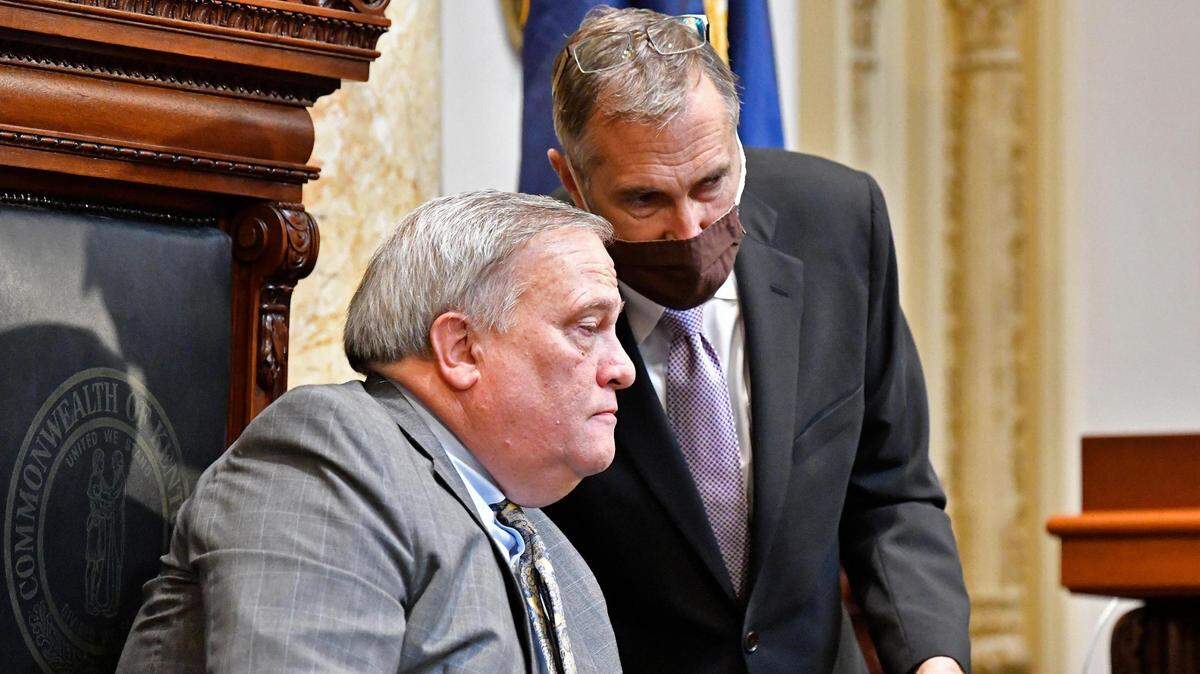 Kentucky Senate President Robert Stivers, left, speaks with a clerk during the opening day of the Kentucky State Legislature special session in Frankfort, Ky., Tuesday, Sept. 7, 2021. (AP Photo/Timothy D. Easley)