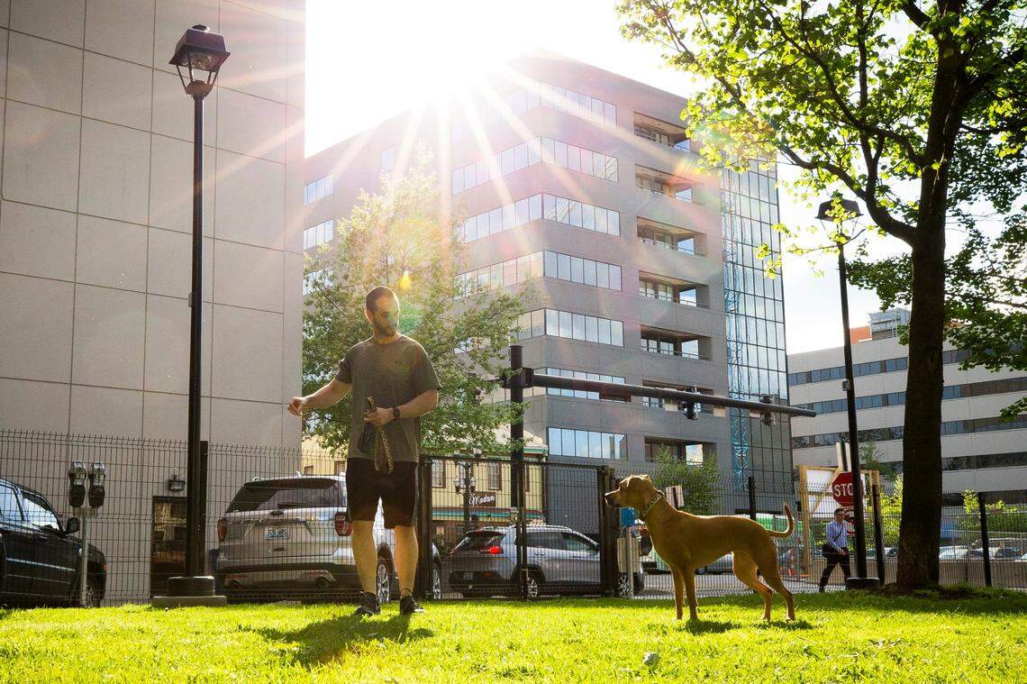 Dennis Shipley, of Lexington, Ky., played with his dog, Chloe, at the then-new dog park at Phoenix Park in downtown Lexington in 2017.