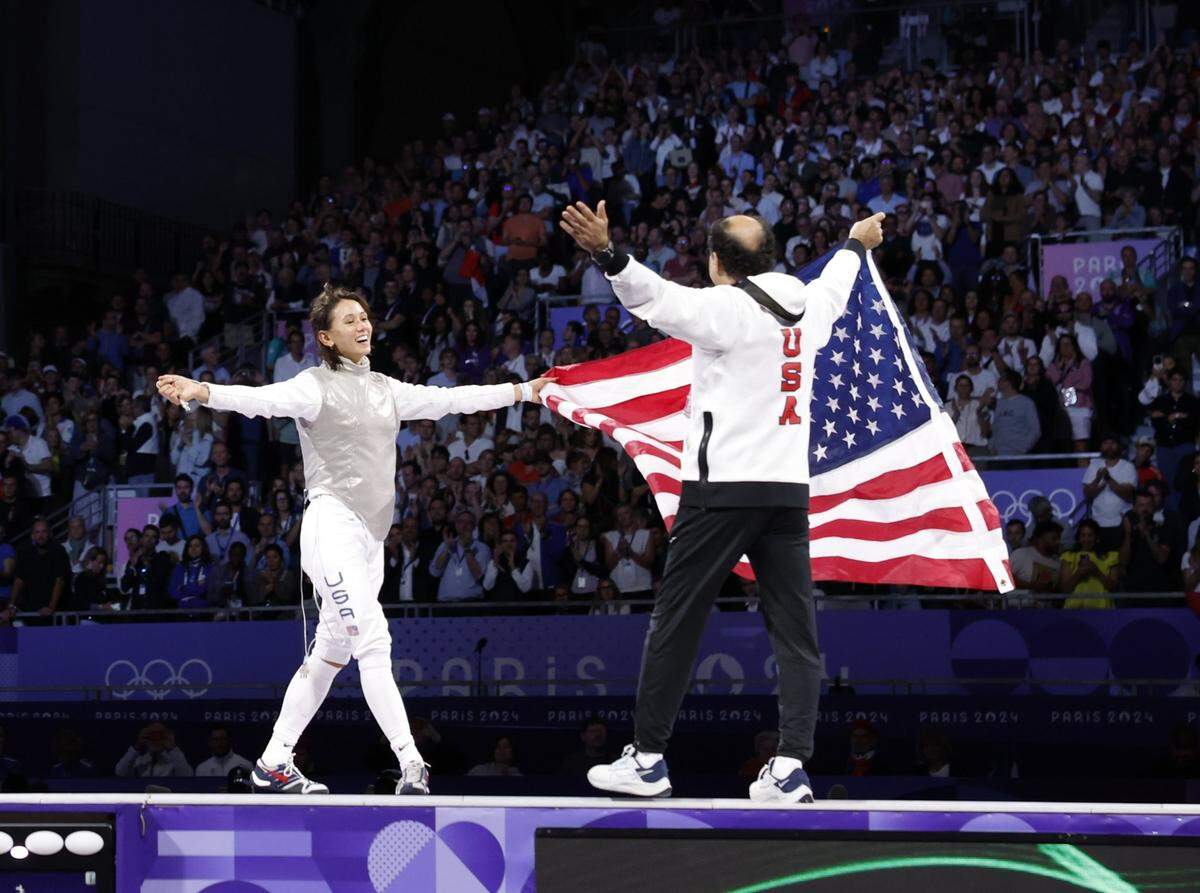 Jul 28, 2024; Paris, France;  Lee Kiefer (USA) celebrates with coach Amgad Khazbak after winning the women's foil gold medal bout during the Paris 2024 Olympic Summer Games at Grand Palais. Mandatory Credit: Yukihito Taguchi-USA TODAY Sports