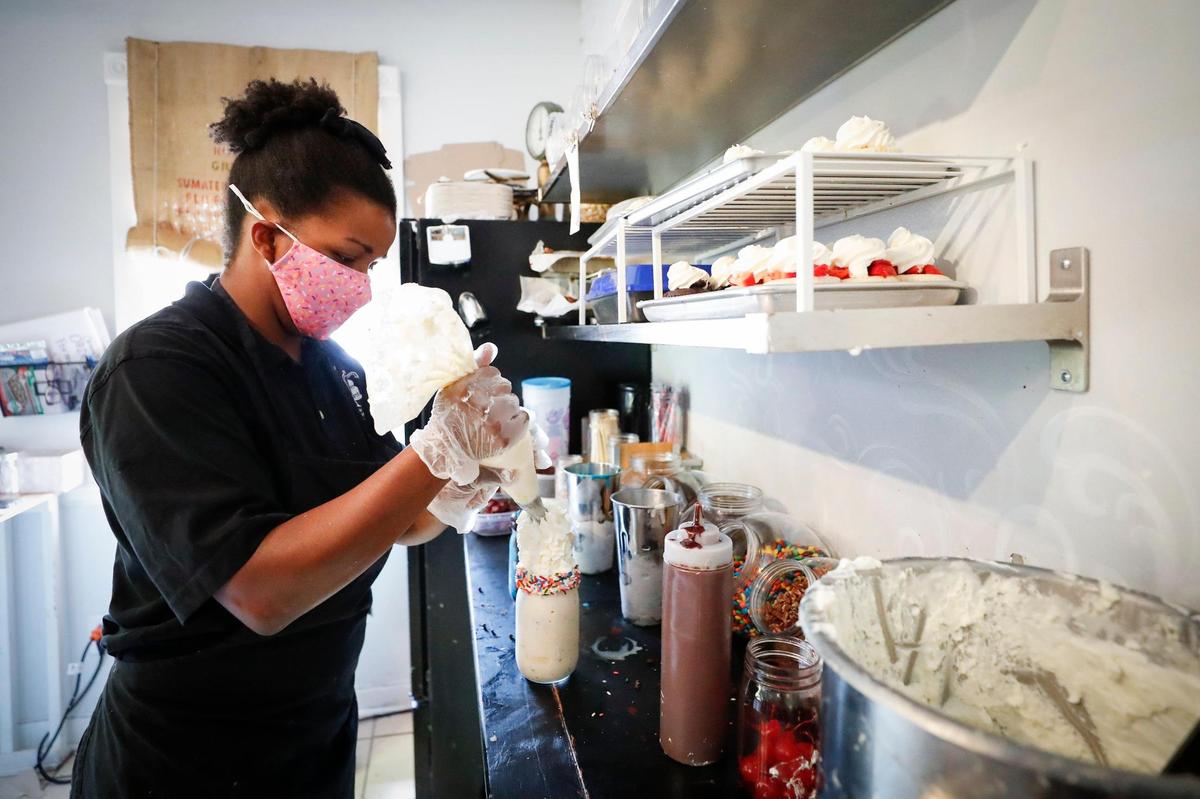 Sweet Matriarch Bakery owner Tia Chancellor works on Cattywampus Milkshake Aug. 15 for a customer. It takes about five minutes to assemble each milkshake, she said.