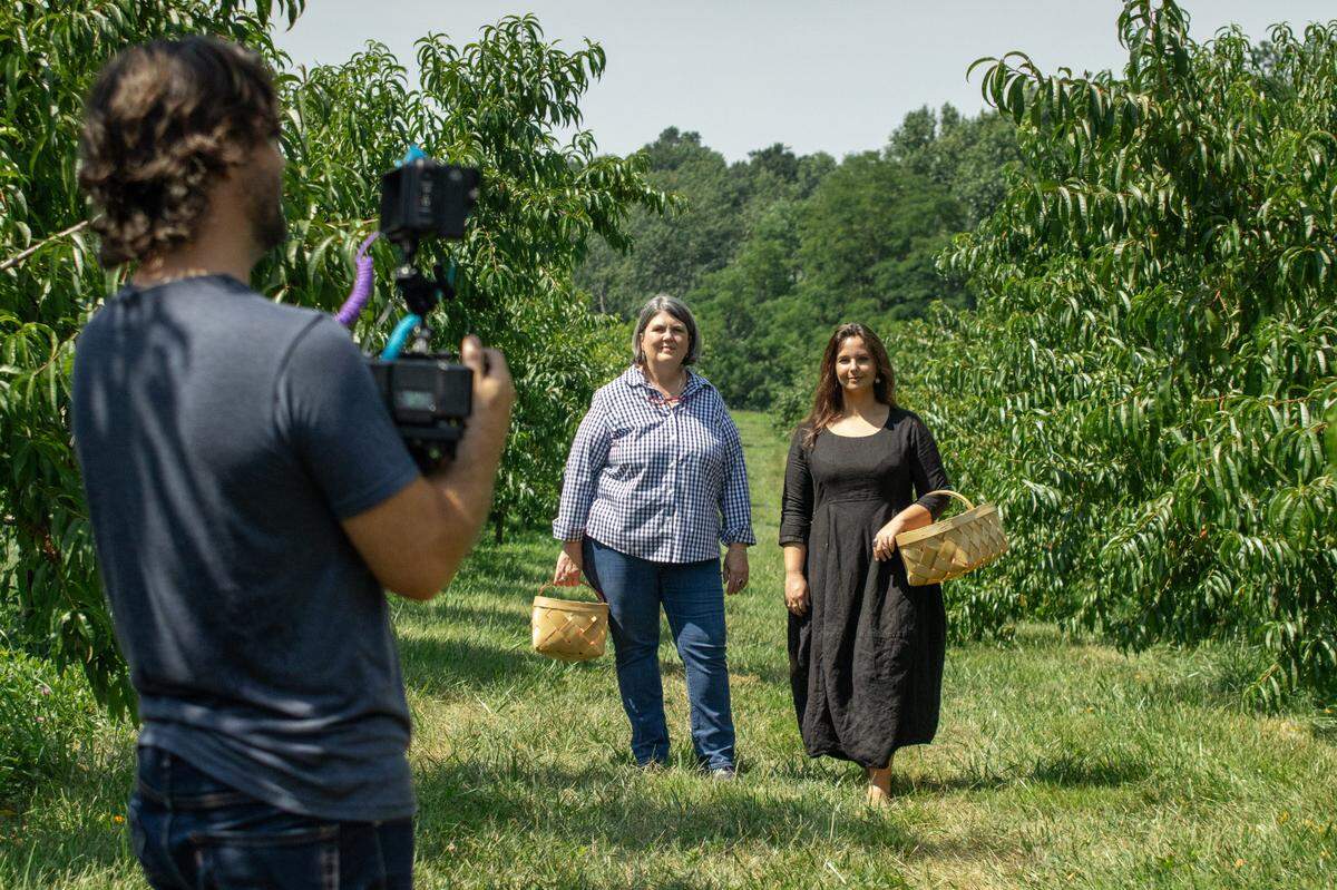 “You Belong Here” features Ouita Michel as well as chefs and farmers from around Kentucky. In a scene from the show, Michel walks with Bee Taylor, whose music is the soundtrack for the series, while they are being filmed by Joseph Matarrese, a cameraman for the series.