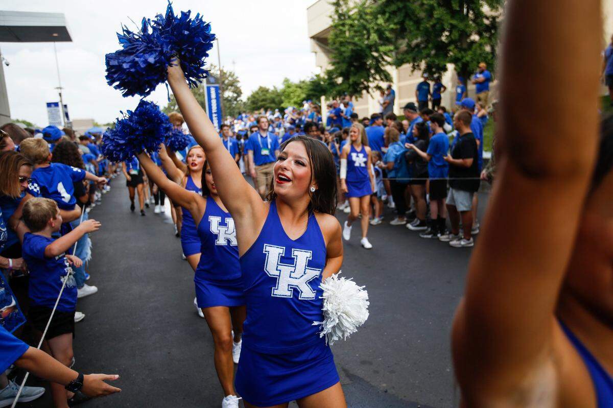 Cheerleaders walk through fans lined up for the Cat Walk before the Kentucky Wildcats face the Miami (Oh) Redhawks at Kroger Field in Lexington, Ky., Saturday, September 3, 2022.