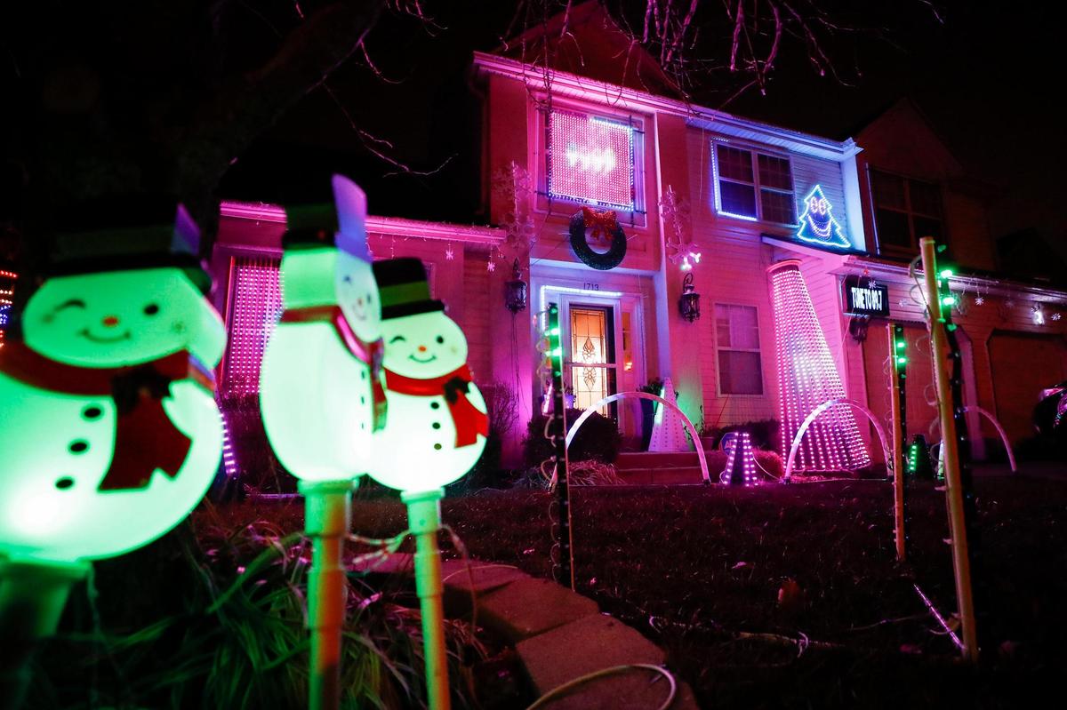 Flashing lights and other decorations surround the home of Reza and Amy Marefat at 1713 Abbington Hill in Lexington, Tuesday, Dec. 8. The lights around the Marefat home are synched to music which plays on FM 89.7.