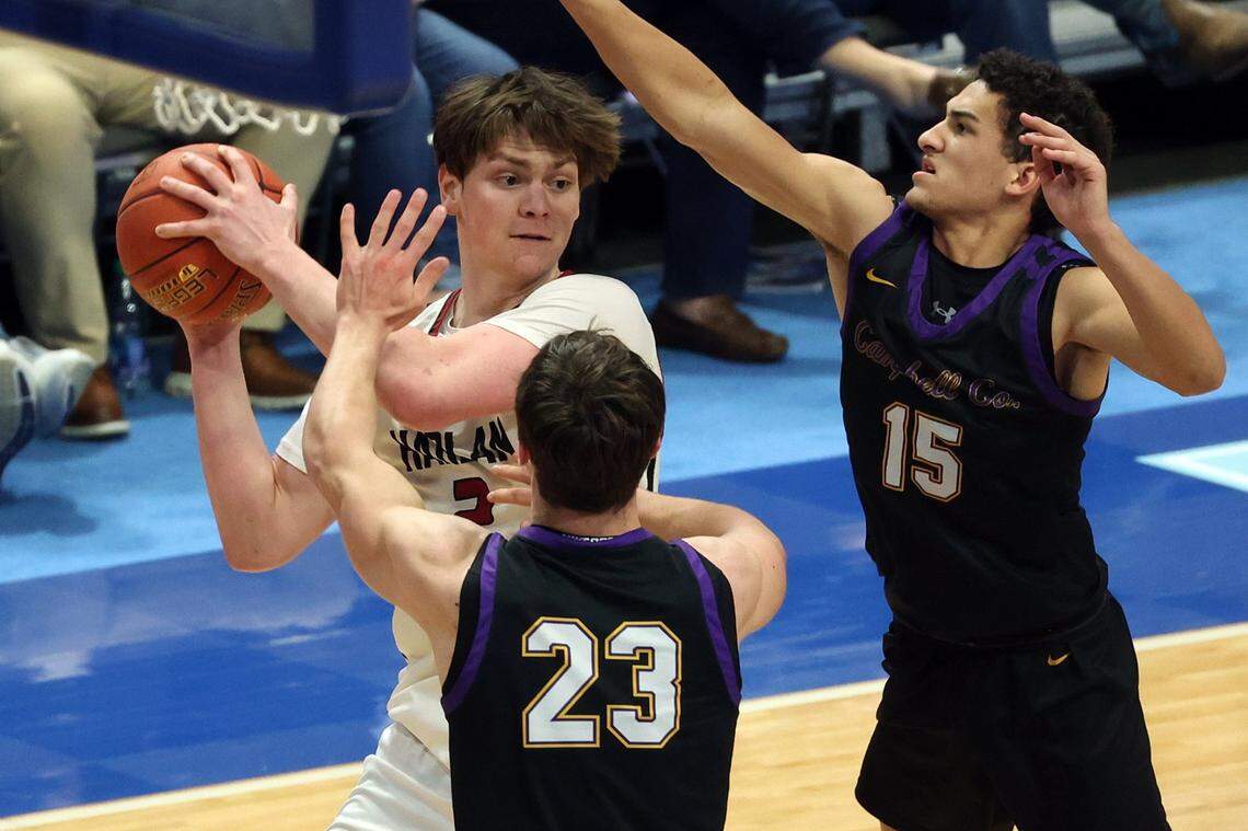 Harlan County’s Trent Noah looks for a teammate while being guarded by Campbell County’s Nathan Smith (23) and Garyn Jackson (15) on Friday night. Noah, who has committed to play college basketball at South Carolina, has scored more career points (3,661) than only four boys’ high school players in Kentucky history.