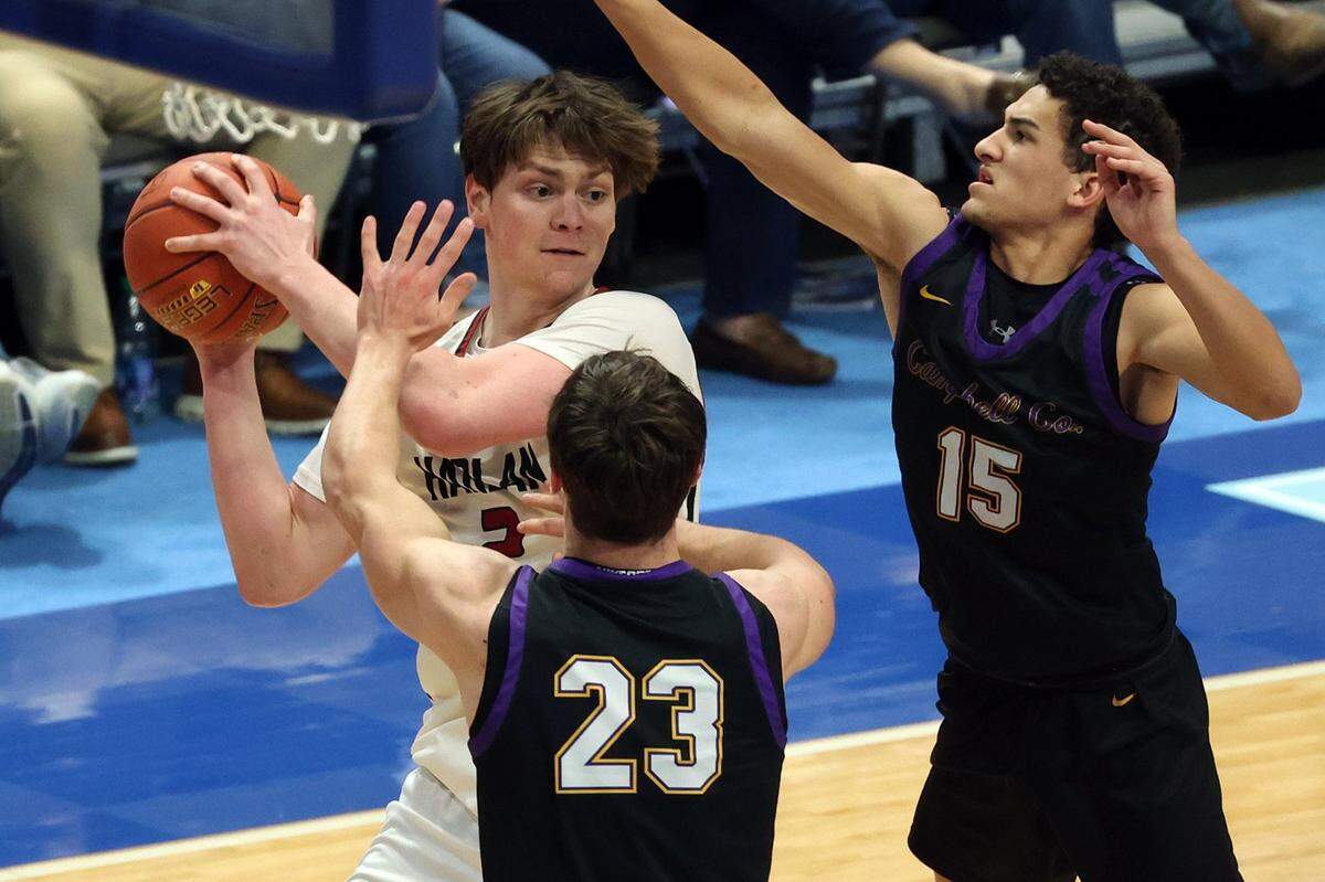 Harlan County’s Trent Noah looks for a teammate while being guarded by Campbell County’s Nathan Smith (23) and Garyn Jackson (15) on Friday night. Noah, who has committed to play college basketball at South Carolina, has scored more career points (3,661) than only four boys’ high school players in Kentucky history.