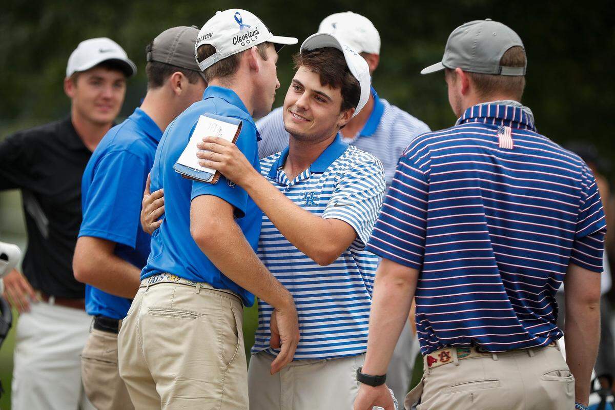 University of Kentucky sophomore Alex Goff (center) shared an embrace with UK senior Jacob Cook after Goff won the 106th men’s Kentucky State Amateur golf tournament at Lexington Country Club on Friday. Cook finished tied for fifth.