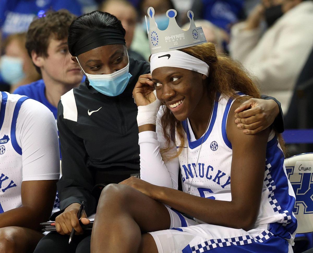 Rhyne Howard gets a hug from associate head coach Niya Butts, left, during Sunday’s Senior Day win over Auburn in Memorial Coliseum. Howard is wearing one of the paper Rhyne Howard-themed crowns distributed to fans for Sunday’s game.