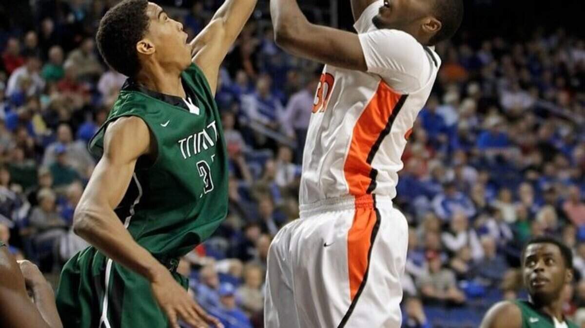 Trinity's Raymond Spalding (35) defended against Jaqualis Matlock in the first quarter of the Hopkinsville vs. Trinity quarterfinal game of the Boys' Sweet Sixteen on March 21, 2014.
